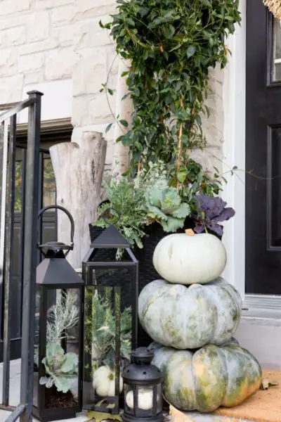 Lanterns, greenery and white pumpkins make a beautiful front porch display (myamazingthings.com)