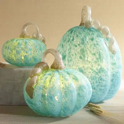 The soft greens and blues of these glass pumpkins add a non-traditional appeal to fall décor (Pinterest)