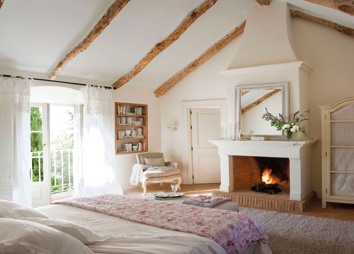 Bedroom with fireplace and attic roof. Curtains and curtains.