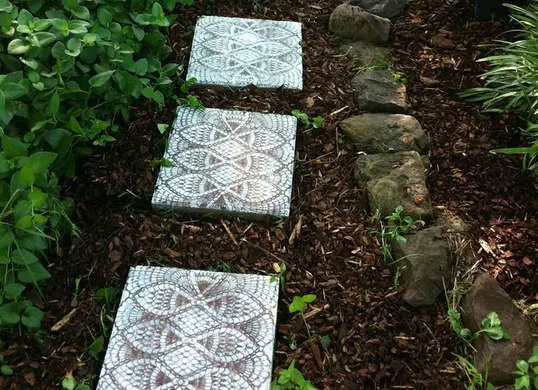 Custom concrete stepping stones make a perfect summer DIY project for kids, but this far-out design is all grown up! All you'll need are standard concrete stepping stones, a rubber doily, and spray paint to transform an ordinary path into a rustic treasure—no concrete mixing required!
