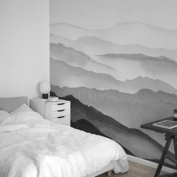 A teenage bedroom with a black and white mountain mural on the wall, expressing individuality.